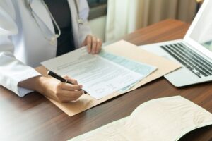 Doctor Writing in Medical Documents