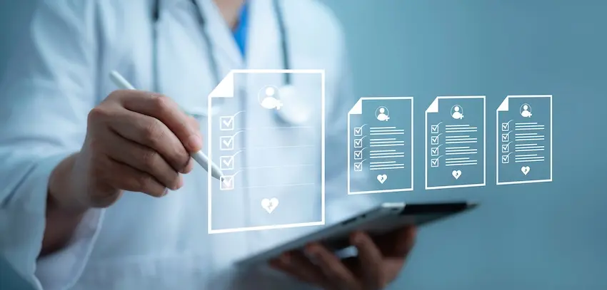 A doctor in a white coat and stethoscope holds a tablet while pointing to a digital overlay displaying multiple patient record icons with checkboxes and health symbols illustrating the thorough medical documentation that physicians compile to support injury victims throughout the treatment and legal claims process with help from Hartley Rowe & Fowler P.C.